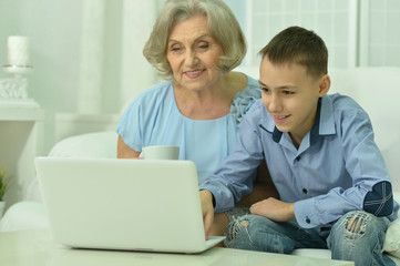 Fototapeta na wymiar grandmother and boy with laptop