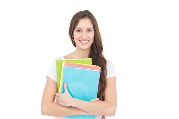 Portrait of smiling female college student holding books 