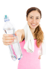 Fitness woman giving a bottle of water
