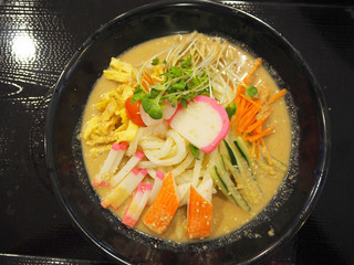 Japanese cold udon with fried eggs and crab stick in white sesame soup