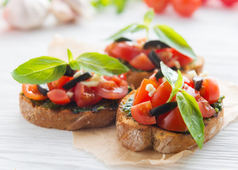 Italian tomato bruschetta with chopped vegetables, herbs and oil