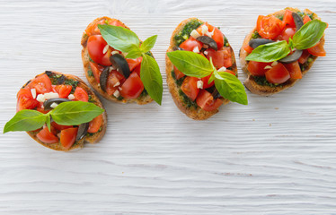 Italian tomato bruschetta with chopped vegetables, herbs and oil