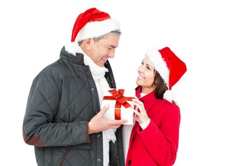 Festive couple holding christmas gift