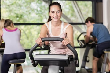 Fit woman doing exercise bike