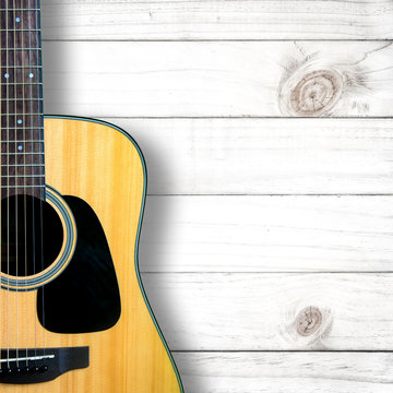 Acoustic guitar on white wood vintage background.