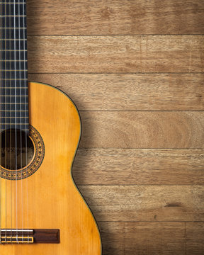 Classic guitar on vintage wood background with copy space.