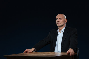 Pensive businessman sitting at the table