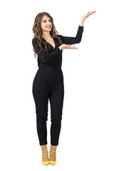 Beautiful fashion model presenter showing hand on copyspace with open palms. Full body length portrait isolated over white studio background.