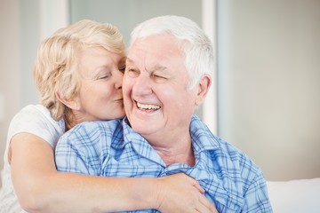 Senior woman kissing husband
