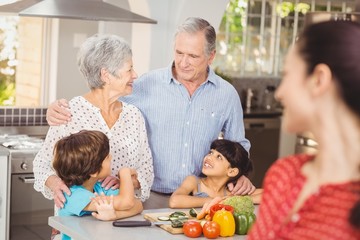Happy family talking in kitchen