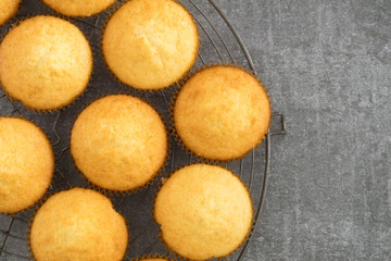 Homemade vanilla cupcakes on a vintage cooling rack
