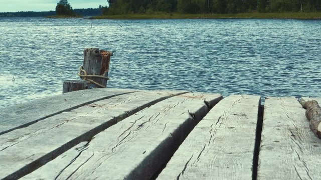Old Wooden Pier With Motor Boad Near it