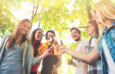 Group of young people cheering, having fun outdoors