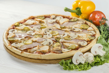 delicious pizza on wooden board with tomato, pepper and mushroom