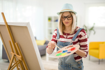 Female artist mixing colors on a palette