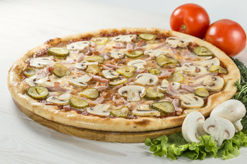 delicious pizza on wooden board with tomato and mushrooms