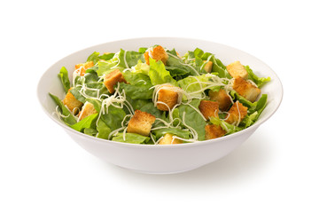 Caesar salad in a white plate isolated 