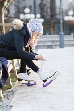 Woman putting ice skates on
