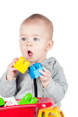 child plays with plastic constructor