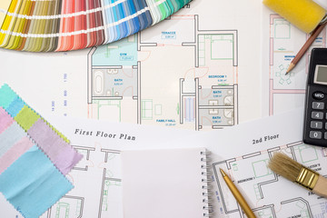Color samples with house plan, calculator and pen