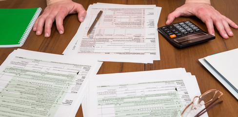 business man filling out usa 1040 tax form