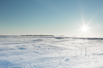 the desolate winter landscape and the sun's rays