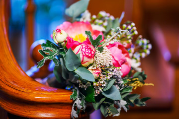 Wedding bouquet of bride colorful pink flowers with greens 
