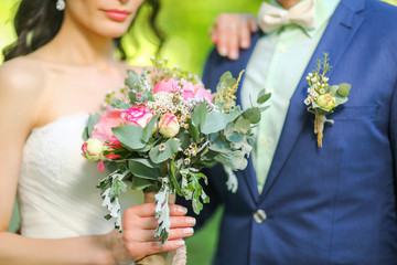 Close-up of bride hands holding beautiful wedding bouquet