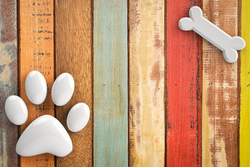 dog bones and dog paw on wooden background