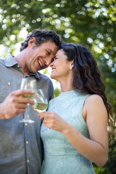 Joyful couple holding wineglasses
