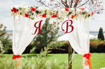  white wedding arch decorated with flower outdoors