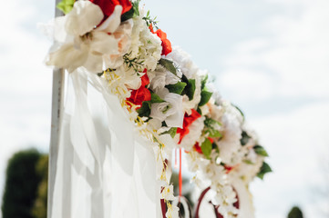  white wedding arch decorated with flower outdoors