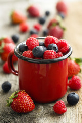 Summer berries in red mug