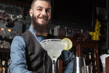 Barman serving cocktail.
