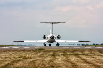 The plane on the runway. Back view