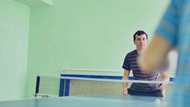 man  playing table tennis slow motion video backhand sport