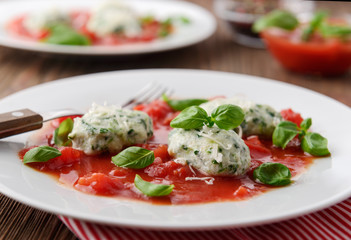 Homemade malfatti with tomato sauce