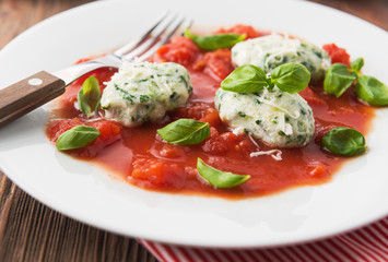 Homemade malfatti with tomato sauce