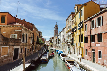 Fototapeta na wymiar Canal with gondolas scene, Venice, Italy.