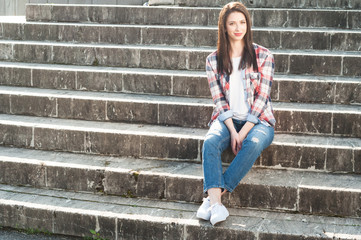 Attractive female in casual clothes relaxing outdoors