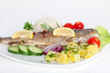 Grilled whole trout with rice, vegetables and lemon, horizontal 