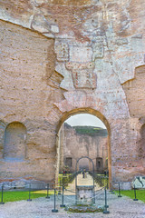 Picturesque view on passage to Frigidarium in the ruins the ancient roman Baths of Caracalla ( Thermae Antoninianae ).Built between AD 212 and 217.Old well in the foreground. Rome. Italy. Europe.