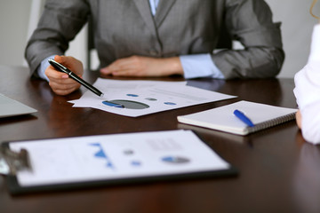 Close up  of unknown  business people at meeting discussing financial results