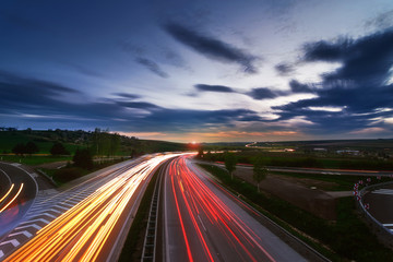 Long-exposure sunset over a highway