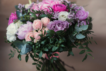 Beautiful bright wedding bouquet of hydrangea, peonies and roses on a background of kraft paper