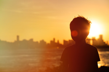 little boy looking at sunset city © nadezhda1906