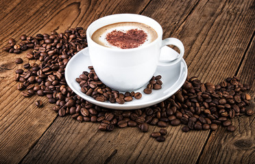 Coffee cup coffee beans on old wooden background