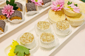 set of cakes and cookies decorated with natural flowers