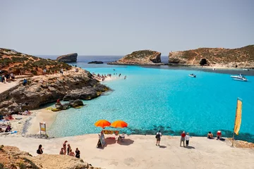 Foto op Canvas BLUE LAGOON, COMINO, MALTA - APRIL 13, 2016. People enjoy blue lagoon  with crystal clear blue water. © twindesigner