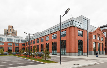 Extensive office complex exterior in loft style. Red brick buildings of former factory, gasholders....
